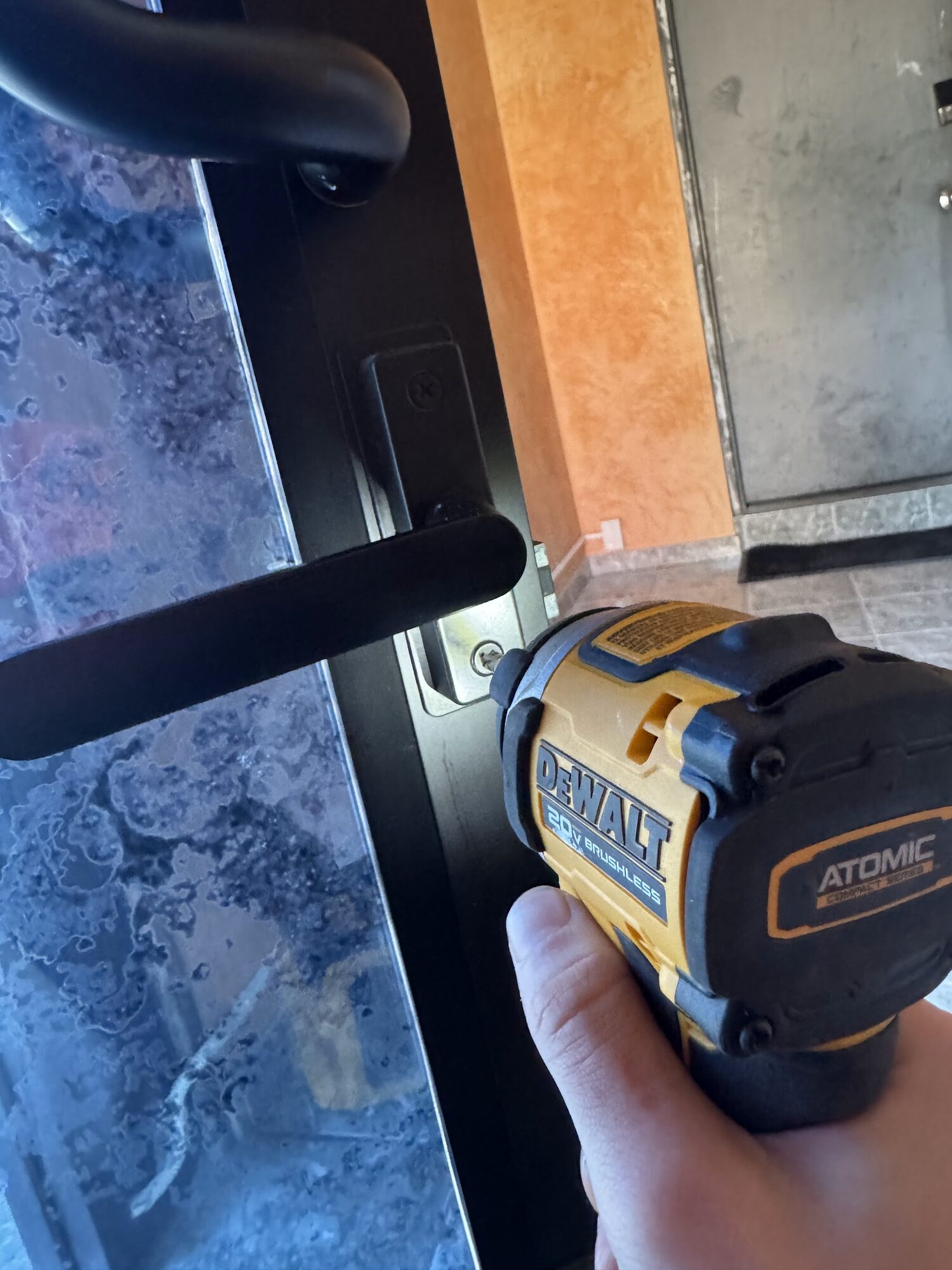 Lever handle going onto a glass door with an impact driver